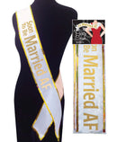 Fun bridal sash with "Soon To Be Married AF" in gold lettering on a mannequin, perfect for bachelorette parties and bridal showers.