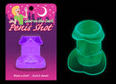 Glow in the Dark Penis Shot Glass in Purple glowing brightly in a dark room - Fun and playful drinking accessory for wild nights.