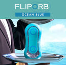 Tenga Flip Orb Ocean Blue Stroker displayed on a platter with ocean background, emphasizing its unique design and features.