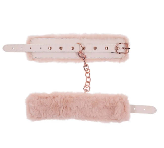 Peaches 'n CreaMe peach-colored faux fur handcuffs with rose gold chain for luxury bondage.