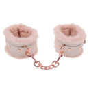 Peach-colored faux fur handcuffs with rose gold chain for luxury bondage play.