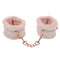 Peach-colored faux fur handcuffs with rose gold chain for luxury bondage play.
