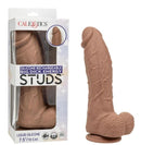 Silicone Stud Big Dick Energy Silicone Vibrating Dildo Brown with packaging, showcasing its realistic design and color.