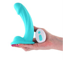Colours Curve Vibrating Dildo 6 Inch with Remote Control Teal held in hand with remote