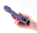 A hand holding the INYA Integra Rechargeable Multifunction Vibrator Purple, showcasing its sleek design and buttons.