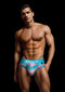 Model wearing ENVY Men's Rainbow Pride Briefs in blue, cotton-spandex blend, size L/XL, with a vibrant rainbow pattern.