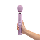 Le Wand Dive Submersible Vibrating Massager Lavender held in hand, showcasing its sleek design and controls.