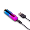 Le Wand Essentials Rechargeable Rainbow Bullet Vibrator connected to USB charger, featuring a vibrant rainbow design.