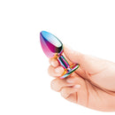 B-vibe Essentials 2-piece Rainbow Bling Anal Training Set in hand, showcasing vibrant rainbow colors.