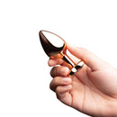 B-vibe Essentials 2-piece Jewel Hearts Anal Training Set held in hand with a shiny golden finish.
