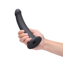B-vibe Essentials 7 Inch Smooth Silicone Dildo Black held in hand, showcasing its sleek design and smooth finish.