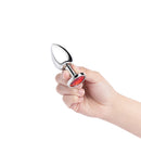 b-Vibe Essentials 3.25 Inch Steel Jewel Butt Plug Red held in hand, featuring a polished stainless steel body and red jewel base.