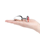 b-Vibe Essentials 3.25 Inch Steel Jewel Butt Plug Red held in a hand showcasing its polished steel and red jewel design.
