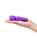 Together Glow On The Go Mini Wand Vibrator Purple held in a hand, showcasing its compact design.