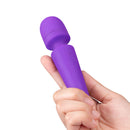 Together Glow On The Go Mini Wand Vibrator Purple held in hand, showcasing its compact design and silicone material.