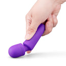 Together Glow On The Go Mini Wand Vibrator Purple being held, showcasing its compact design and vibrant color.