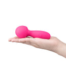 Together Spark On The Go Mini Wand Vibrator held in a hand, showcasing its compact and travel-friendly design.