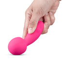 Together Spark On The Go Mini Wand Vibrator held in hand, showcasing its compact and ergonomic design.