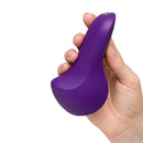 We-Vibe Shared Touch Couples Grinding Vibrator Purple held in hand, showcasing its ergonomic design.