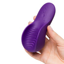 We-Vibe Shared Touch Couples Grinding Vibrator Purple held in hand, showcasing its textured design for dual stimulation.