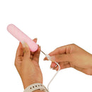 Person holding the Softies Dual Layer Bullet Vibrator 4 Inch Pink while connecting the charger.
