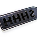 Sei Mio Double Trouble Shhh Oops Double-Sided Paddle displaying a playful black design with cut-out letters.