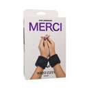Merci Velvet Wrist Cuffs Violet and Black packaging with soft velvet cuffs and hands clasped.