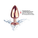Dorcel Diamond Butt Plug Rose Gold Large with a polished finish and temperature-responsive metal, showcased with water splashes.