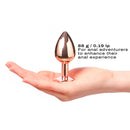Dorcel Diamond Anal Plug Rose Gold Medium held in hand, showcasing its elegant design for anal adventurers.