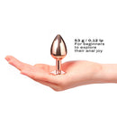 Dorcel Diamond Butt Plug Rose Gold Small held in a hand, showcasing its elegant design for beginners.