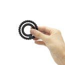 Dorcel Dual Ring Double Cock Ring held in hand, showcasing its elegant two-ring design for enhanced intimacy.