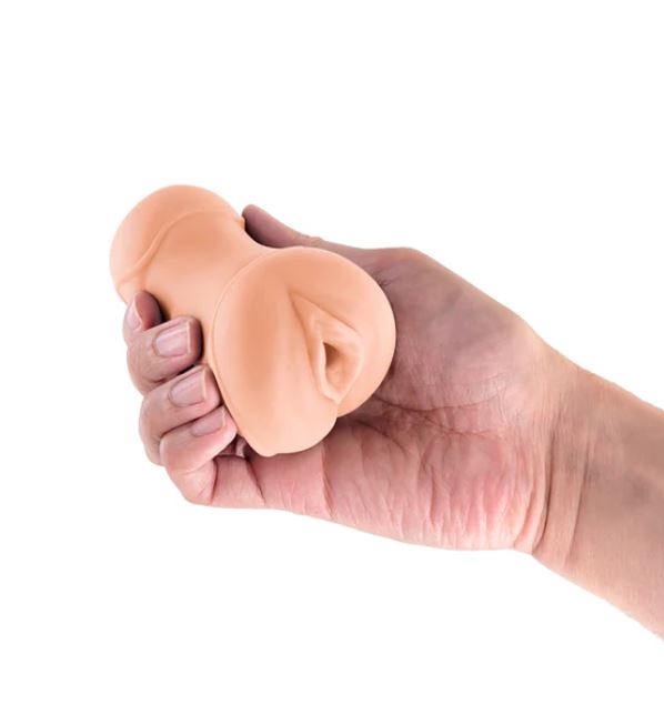 Hand holding the Pocket Pals Stroker Pussy Caramel demonstrating its realistic design and soft texture.