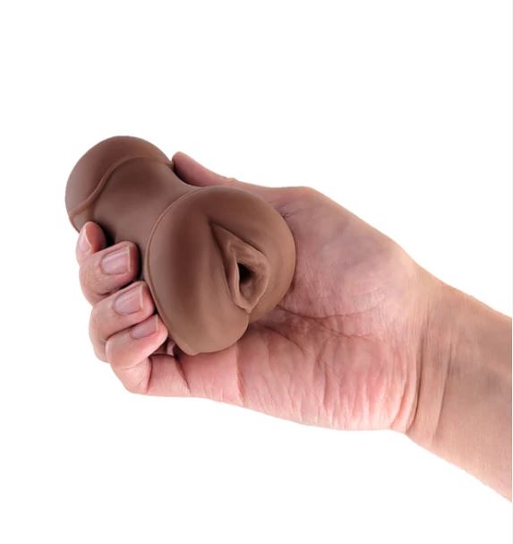Hand holding the Pocket Pals Stroker Pussy Chocolate for intimate self-care and satisfaction.