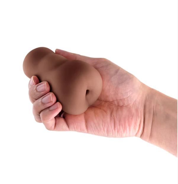 Pocket Pals Stroker Ass Chocolate held in hand showcasing its realistic design and body-safe material.