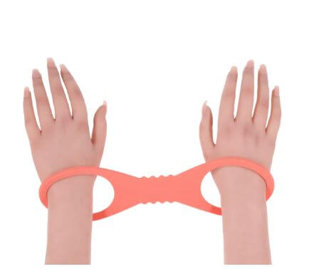 Peaches N Creame Silicone Cuff Large on two hands, showcasing comfort and flexible restraint.