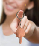 Super Fun Penis Middle Finger Key Chain held by a smiling woman, showcasing the playful novelty design.