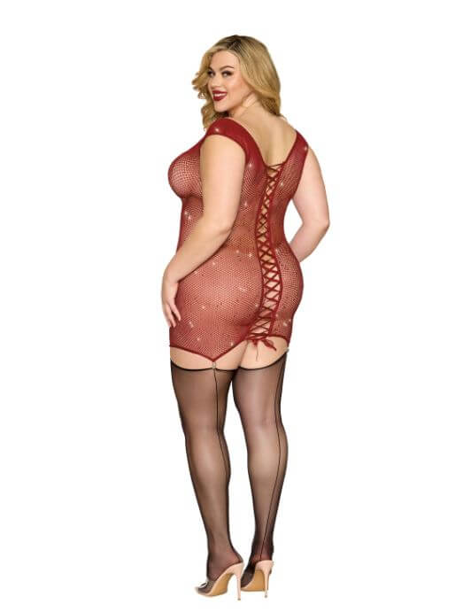 Oxblood seamless garter slip with iridescent rhinestones, keyhole openings, bow accents, and satin ribbon lace-up back, worn by model.