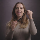 Nexus Excite Silicone Anal Beads Small Black shown by a woman in a beige sweater.