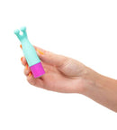MACI Magnetic Mini Vibe in hand, turquoise and pink, showing compact and portable design for discreet pleasure anywhere.