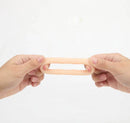 Maia Gunner Vanilla Liquid Silicone C Ring being held to demonstrate its stretchy design and comfort.
