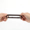 Maia Gunner Liquid Silicone C Ring Chocolate being held, showcasing its stretchy and durable design.