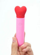Maia Sweetee Rechargeable Mini Vibe in hand, featuring a heart-shaped head and pink body for easy portability.