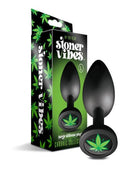 Large Stoner Vibes anal plug with cannabis charm, smooth silicone, in front of packaging from Chronic Collection.