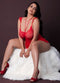 Seductive model in sheer mesh red Baby Doll & Thong Set with scalloped lace cups, sitting on plush white fur.