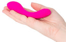 The Mini Swan Wand 4.75 inches Pink held in a hand, showcasing its compact design and vibrant color.