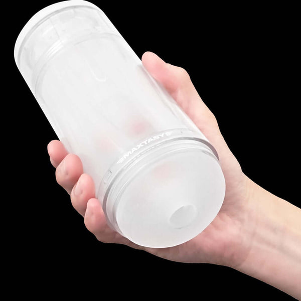 Hand holding MAXTASY Show Master Pleasure Stamina Trainer with ultra-soft sleeve