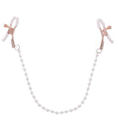 Adjustable rose gold nipple clamps with pearl accents and white rubberized tips for intimate play.