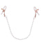 Adjustable rose gold nipple clamps with pearl accents and white rubberized tips for intimate play.