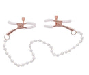 Rose gold adjustable nipple clamps with pearl accents and white rubber tips for enhanced sensitivity and secure intimate play.