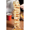 Tower Tease Table Adult Game with stacked wooden blocks and colorful cup in a lively party setting.